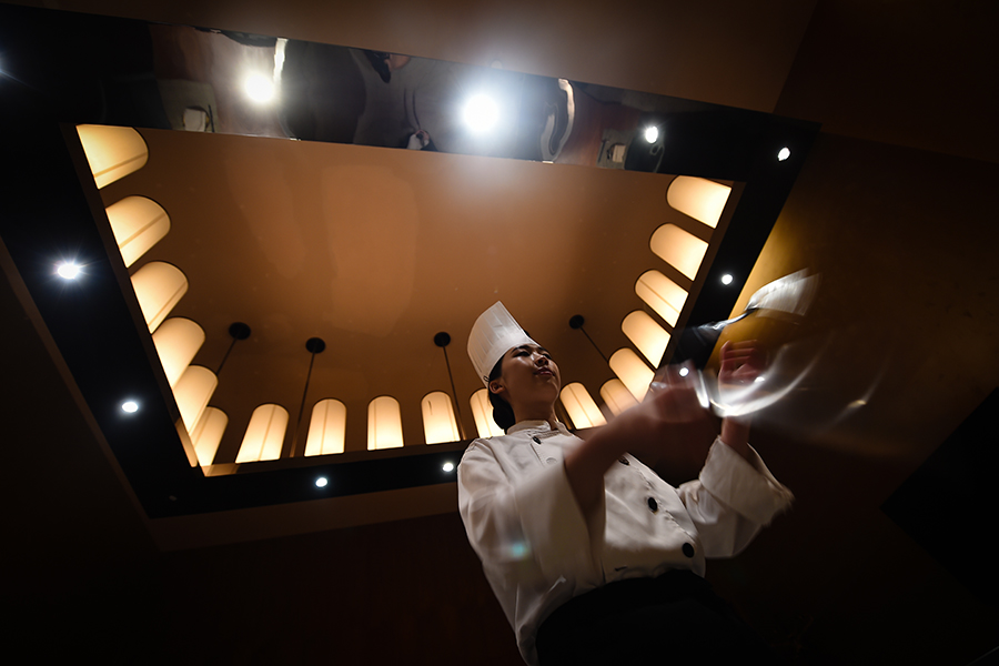 Young female chef performs for five-star hotel guests