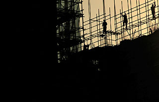 Labourers work on the scaffoldings at a construction site in Nanjing, capital of east China's Jiangsu province July 13, 2006.