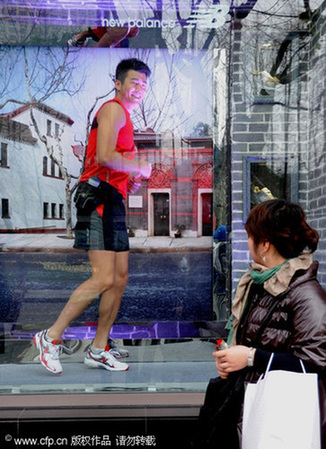 Model jogs in window to promte a healthy workout