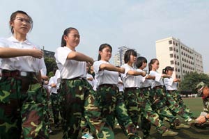 Military training with bottles balanced on heads