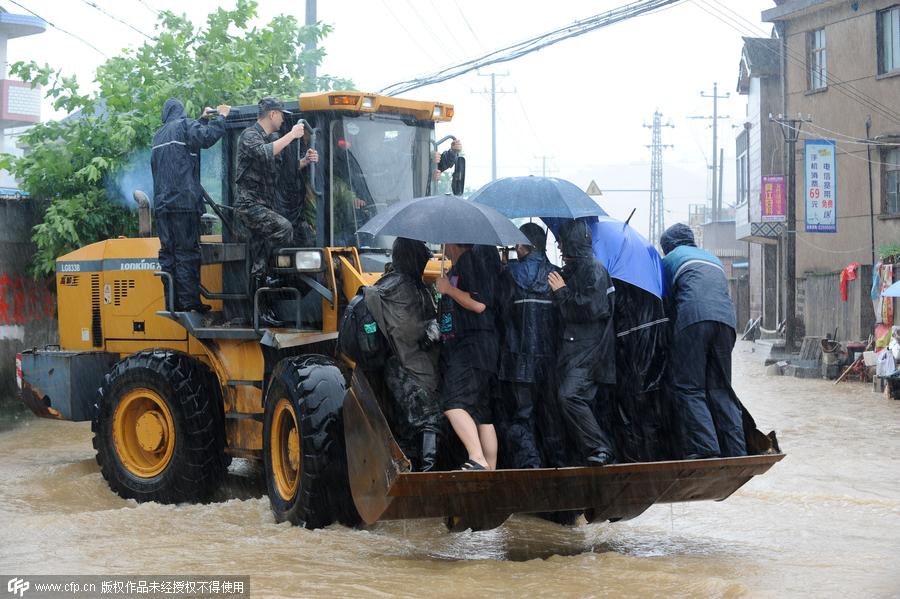 Rescuers help people flee flooding as typhoon hits Zhejiang province