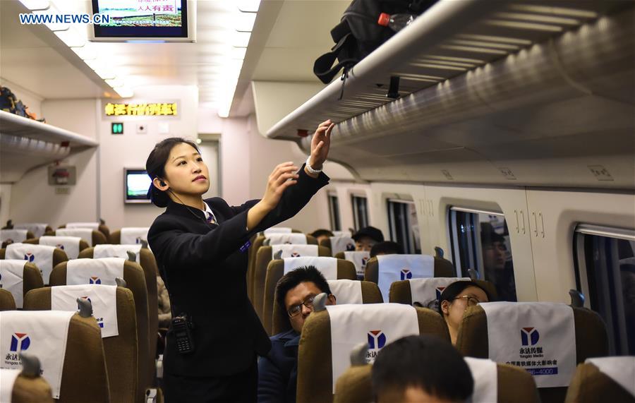 Young couple as railway workers busy for Spring Festival travel rush