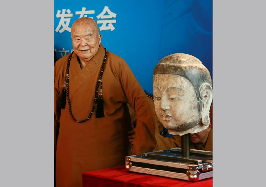 Stolen Buddha head statue returns to Chinese mainland after 20 years