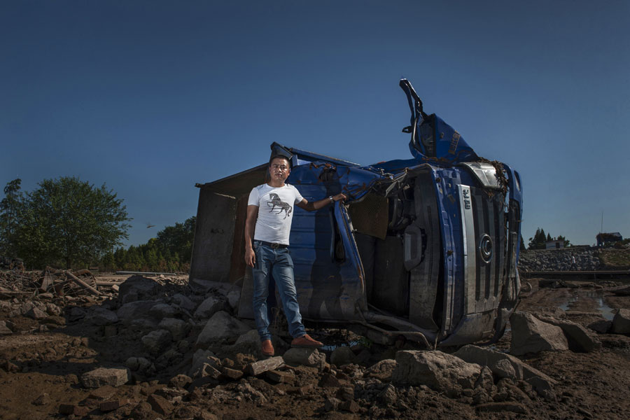 Residents sacrifice their vehicles to stop flood waters