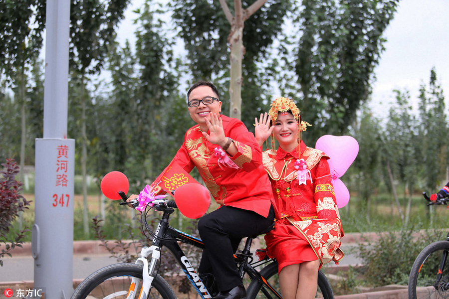 Groom and bride cycle their way to wedding