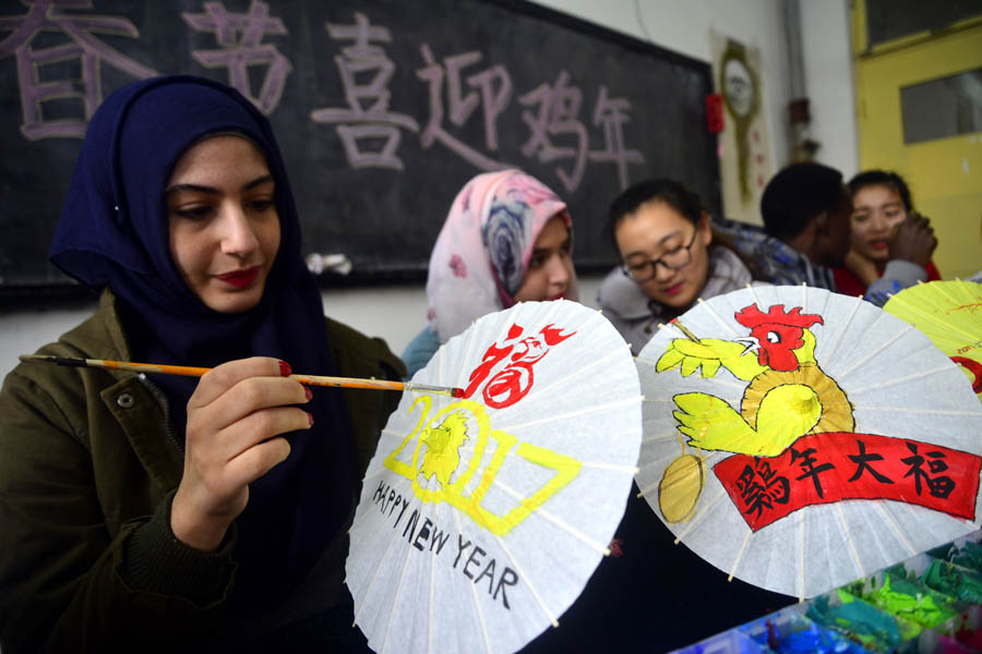 Int'l students paint patterns on umbrellas to greet Year of Rooster