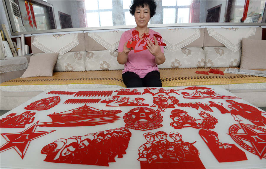 Artist creates paper-cuts to mark PLA's 90th anniversary