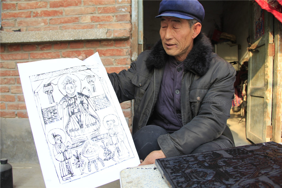 Folk artists create lunar New Year's woodblock paintings in C China