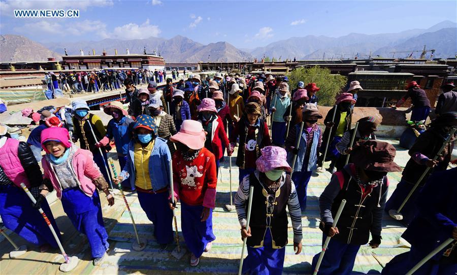 Craftswomen repair roof of Tibet monastery