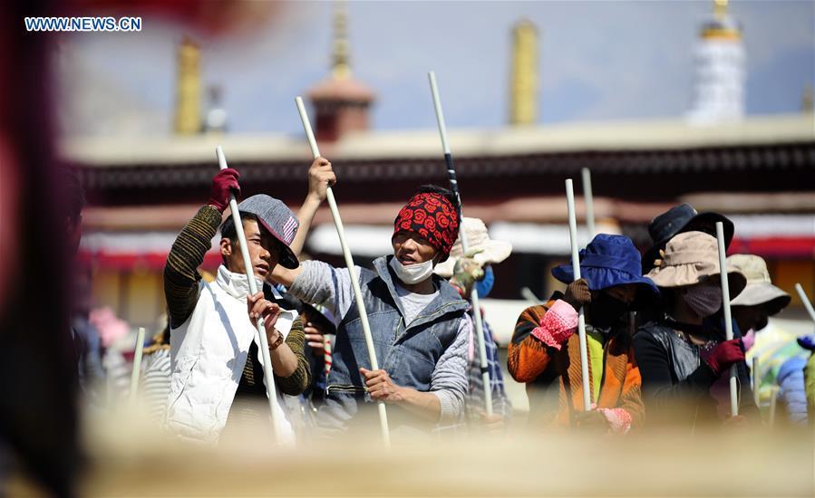 Craftswomen repair roof of Tibet monastery