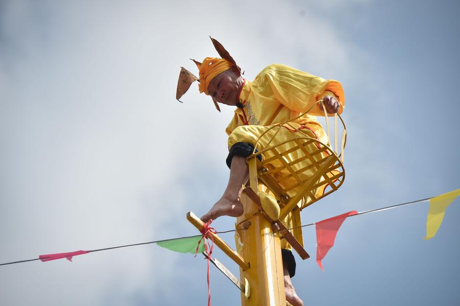 Stunt 'climbing on blades' performs in China's Fujian province