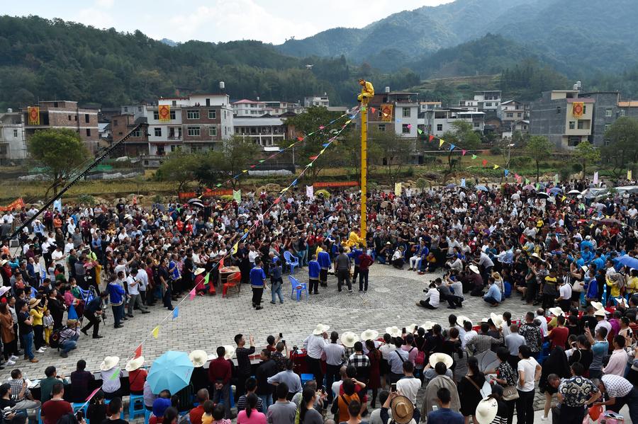 Stunt 'climbing on blades' performs in China's Fujian province