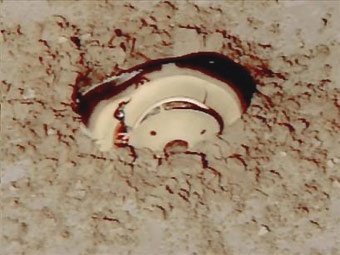 This image from television shows the Genesis space capsule after it crashed in Utah's west desert at the Dugway Proving Ground, Wednesday, Sept. 8, 2004. [AP]