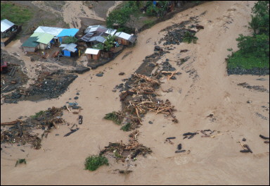 A total of 165 people are dead or missing after two storms tore through the Philippines in a week, the government says. Here, floodwaters in Dingalan town. [AFP]