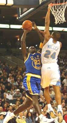 Golden State Warriors' Jason Richardson, left, shoots over Denver Nuggets' Andre Miller (24) in the first half in Oakland, Calif. on Monday, Dec. 27, 2004. [AP]