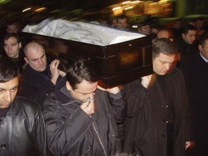 Georgians carry the coffin with the body of their late Prime Minister Zurab Zhvania to the Holy Trinity cathedral Tbilisi, late Saturday, Feb. 5, 2005. The stunned ex-Soviet republic struggles to come to grips with the unexpected death two days earlier of the man who had been expected to champion the government's ambitious anti-corruption program and efforts to peacefully rein in separatist regions. Zhvania's death was officially attributed to carbon-monoxide poisoning from an improperly ventilated gas space heater at the apartment of a friend who also died.(AP Photo/George Abdaladze) 