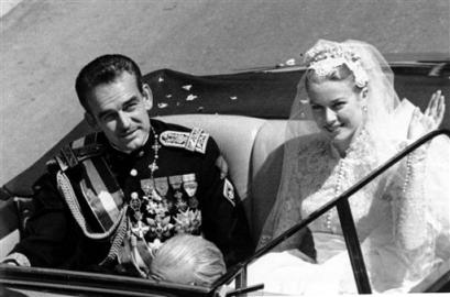 Princess Grace Kelly waves to cheering crowds lining the road as she rides in an open car with Prince Rainier III following their marriage in a religious wedding ceremony in the Monaco Cathedral, in this April 19, 1956 file photo. Many see Rainier's ailing health as the final chapter of a fairy tale romance between an American movie queen and a European prince Friday which has captivated the world , Friday, March 25, 2005 and whose mystique has endured the two decades since her tragic death. (AP Photo