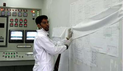 A man works inside a Uranium Conversion Facility producing unit in Isfahan, 340 km (211 miles) south of Tehran, March 30, 2005. France, Britain and Germany are considering letting Iran keep nuclear technology that could be used to make bombs, an apparent move towards a compromise with Tehran, diplomats said on Wednesday. REUTERS/Raheb Homavandi