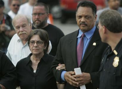 The Rev. Jesse Jackson, right, walks with Terri Schiavo's mother Mary Schindler, left, and Terri's father Bob Schindler, behind Mary, outside the Woodside Hospice, where Terri is a patient, Wednesday afternoon March 30, 2005 in Pinellas Park, Fla. (AP Photo/Evan Vucci)