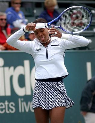 Venus Williams reacts during her 7-5, 6-4 loss to 17-year-old Tatiana Golovin, of France, at the Family Circle Cup tennis tournament in Charleston, S.C., Thursday April 14, 2005. (AP Photo/Paula Illingsworth) 