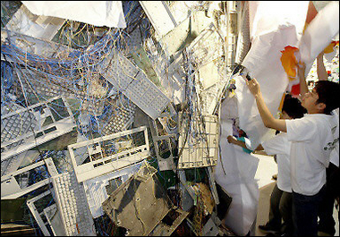 Greenpeace activists set up the e-waste sculpture at a high-tech exhibition in Beijing. Greenpeace warned that China has become a major dumping ground for electronic waste and risks becoming the world's high-tech waste bin, posing hazards for people and the environment.[AFP]