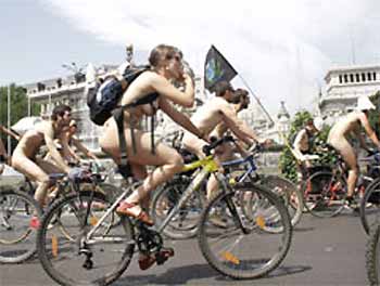 A group of naked cyclists ride past the Cibeles statue in central Madrid Saturday. The cyclists were protesting the lack of cycling lanes in the capital drawing attention to the numerous accidents with other vehicles. (AP