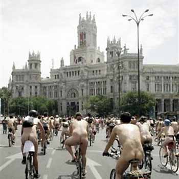 A group of naked cyclists ride towards the Communications Palace in central Madrid Saturday June 11, 2005. The cyclists were protesting the lack of cycling lanes in the capital drawing attention to the numerous accidents with other vehicles. (AP