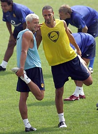 Manchester United's England internationals Rio Ferdinand (right) and Alan Smith stretch during a light training session in Beijing's Worker's Stadium yesterday. [AFP]