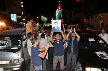 Jordanians celebrate in Aqaba, Jordan, late Monday, Aug.22, 2005. A Syrian linked to an Iraq-based terrorist group has been arrested as the prime suspect in the rocket attack that barely missed U.S. warships docked in the port of Aqaba, the Jordanian government said Monday. 