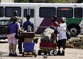 Residents of the Bywater neighborhood speak to a National Guard soldier who was evacuating residents by bus in New Orleans September 4, 2005 during the aftermath of Hurricane Katrina.