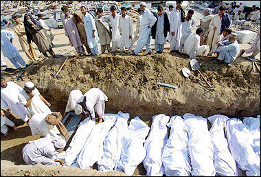 Volunteers bury bodies of Pakistani earthquake victims in a mass grave in Balakot, North West Forentier Province (NWFP), two days after a powerful earthquake rocked the region.