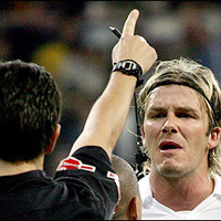 Real Madrid's David Beckham (C) screams at referee Dauden Ibanez (L) after being expelled during a Spanish League football match between Real Madrid and Valencia at the Santiago Bernabeu stadium in Madrid. Valencia won 2-1