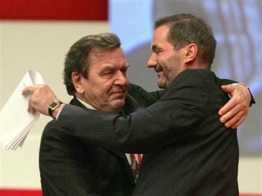 Outgoing Chancellor Gerhard Schroeder, left, and Matthias Platzeck embrace during the party congress of Germany's Social Democrats in Karlsruhe, Germany, Tuesday Nov. 15, 2005.