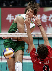 Andre Heller of Brazil(L) spikes the ball past US Ryan Millar during the 2005 World Grand Champion Cup men's volleyball in Nagano. Brazil won 25-27, 25-22, 25-19, 26-24