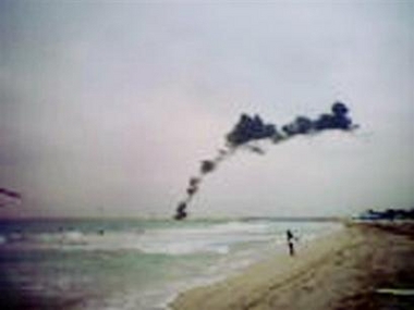 The smoke trail from a Chalk's Ocean Airways drops into the ocean Monday, Dec. 19, 2005 next to Miami Beach.