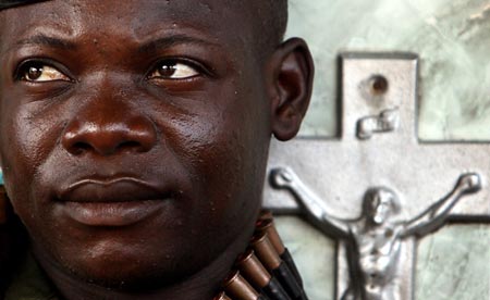 A Congolese soldier rests in a cemetery near the office of Vice President Jean-Pierre Bemba in Kinshasa November 12, 2006. Forces loyal to Congo's rival presidential contenders fought gun battles in the capital Kinshasa in the latest violence to mar historic elections meant to end a decade of war and chaos.