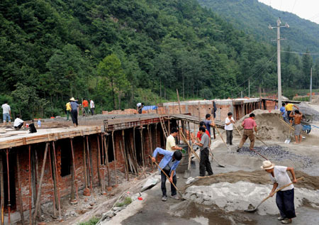 100 days after killer quake, people remember and rebuild