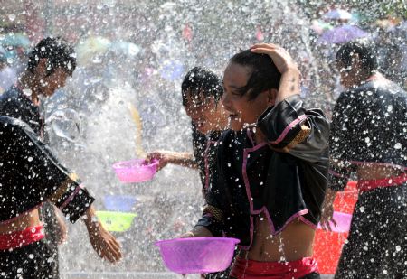 Young people spray water to each other during Double Seventh Festival