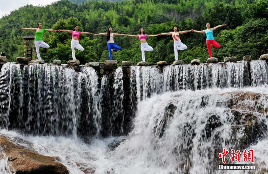 Yoga performed around waterfall in Jiangxi