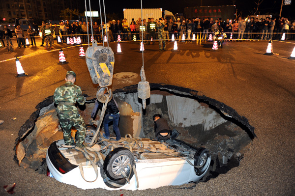 Car plunges into sinkhole