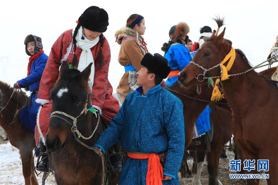 Horses gallop through snow-covered land