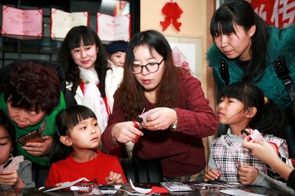 Young pupils learn paper cutting