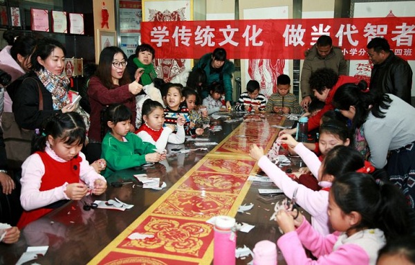 Young pupils learn paper cutting