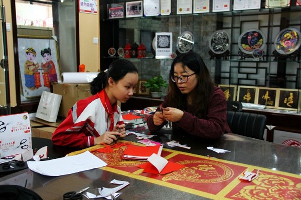 Young pupils learn paper cutting