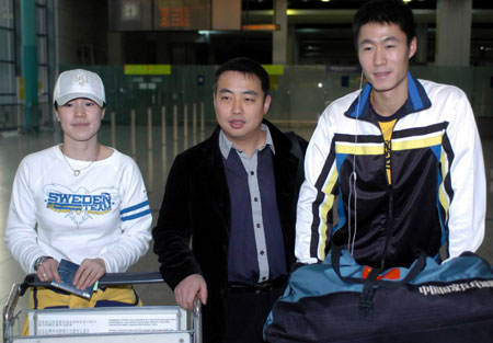 China's table tennis veterans Wang Nan (L) and Wang Liqin (R) walk out of the rail station in Hong Kong with men's team coach Liu Guoliang, March 3, 2008. Two Wangs will represent China in the Asian qualifiers for the last two Olympic berths. Four places in the host's team for the Games have already been taken by Ma Lin, Wang Hao, Zhang Yining and Guo Yue, leaving two spots up for grabs at the Asian Olympic qualifiers, which start on Thursday. [Xinhua]