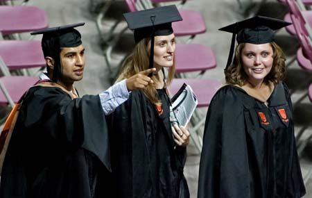 Virginia Tech graduate students wave to family and friends while walking in prior to the graduate commencement ceremony at Cassell Coliseum on the campus of Virginia Tech in Blacksburg, Virginia May 11, 2007. On April 16 then Virginia Tech student Seung-Hui Cho killed 32 students and faculty before killing himself in the deadliest shooting in U.S. history . Some 3,600 seniors graduated from Virginia Tech. 