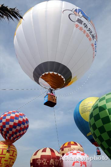 Hot air balloons color S China city sky