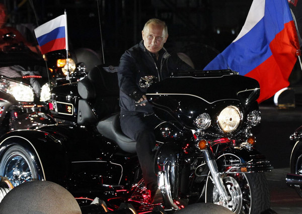 Putin rides with 'Night Wolves' at bike festival