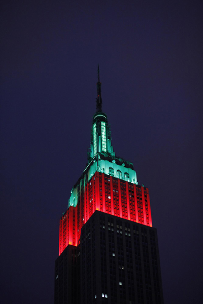 Empire State Building lit up in red and green