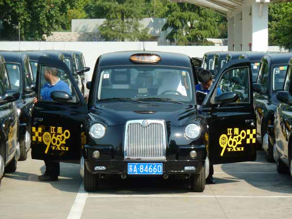 Classic British taxi cabs on road in E China